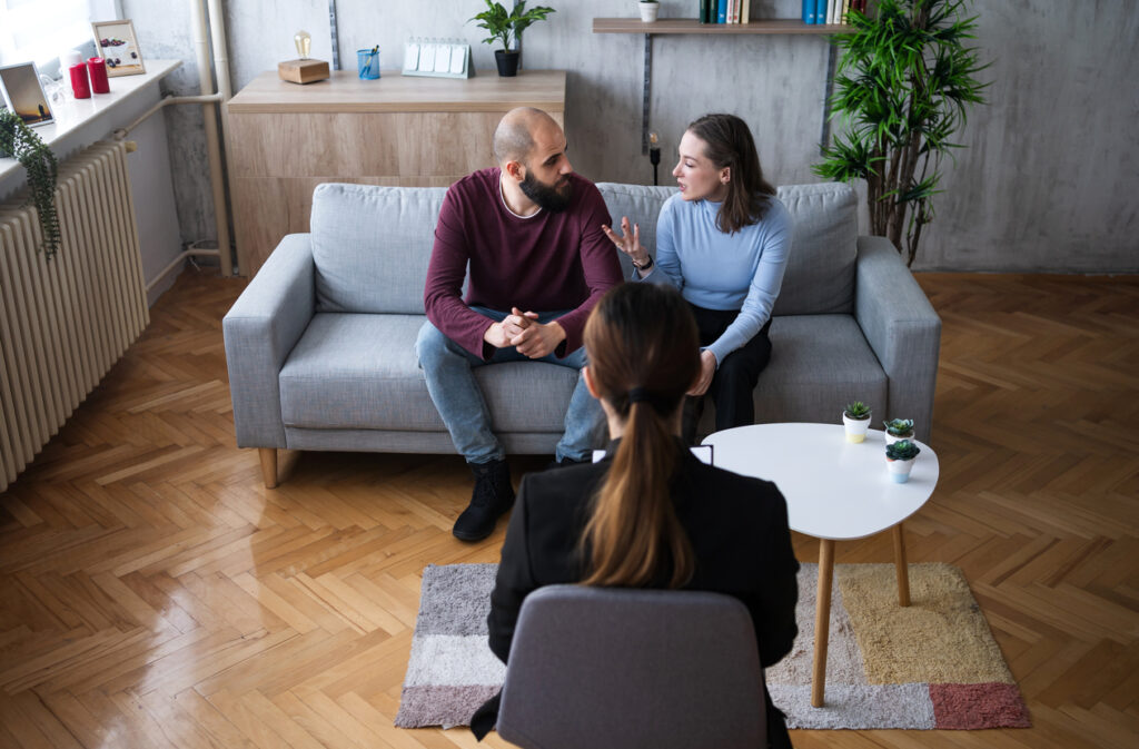 Separated parents attending a parenting course session in a supportive, professional setting
