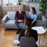 Separated parents attending a parenting course session in a supportive, professional setting
