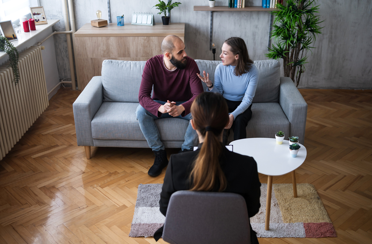 Separated parents attending a parenting course session in a supportive, professional setting