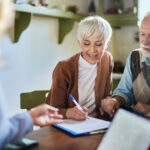 Couple signing enduring power of attorney with NSW estate planning lawyer