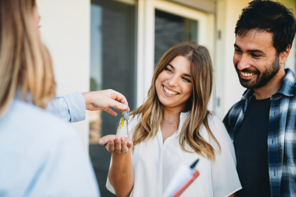Homebuyers receiving keys after property settlement in NSW
